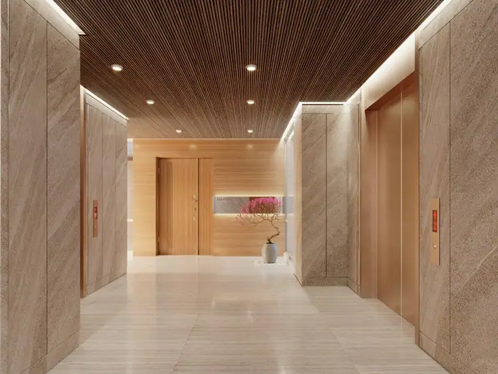 Modern hotel lobby with elevators and wood accents