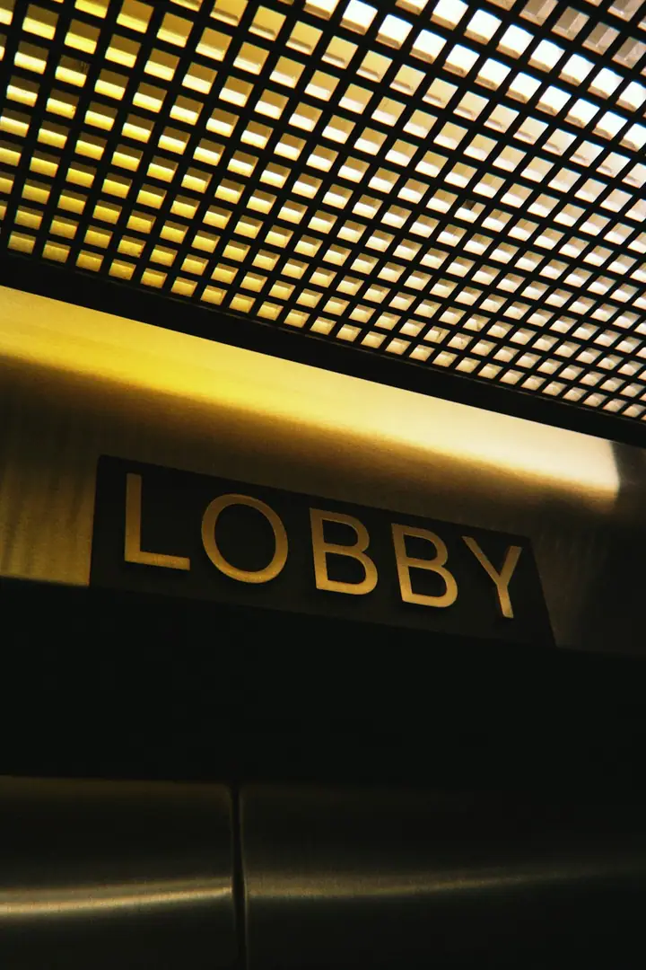 Golden sign reads lobby above brushed metal